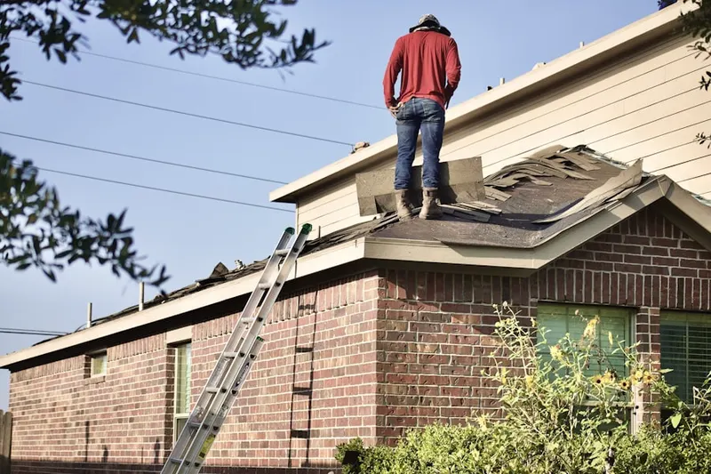 Professional roofer working on a residential roof in Berwyn Heights